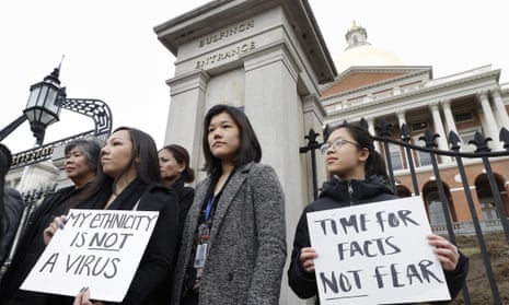 Members of the Massachusetts’s Asian American Commission protest racism aimed at Asian communities amid the coronavirus pandemic at the statehouse in Boston.