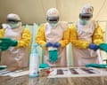 Three health workers in full PPE taking part in a training session