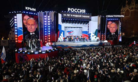  Vladimir Putin addresses the crowd during a rally and a concert celebrating the 10th anniversary of Russia's annexation of Crimea at Red Square in Moscow.