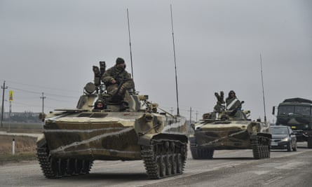Russian soldiers on the amphibious infantry fighting vehicle BMP-2 move towards mainland Ukraine on the road near Armiansk, Crimea, 25 February