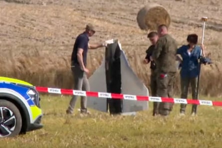 Military police secure parts of a damaged object shot down by authorities in Wohyń, Poland.