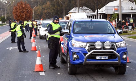 Police patrol the southern NSW border city of Albury as cars cross over from Victoria on 8 July.
