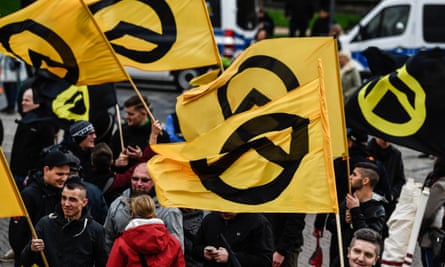 Protesters carry flags of the far-right Identitarian movement as they gather at a rally in Dresden, Germany, October 2017