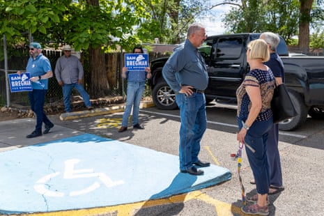 Sam Bregman, third from right, speaks with voters on primary Election Day, Tuesday, June 2, 2026, at Valley High School in Albuquerque, New Mexico. (AP Photo/Jon Austria)