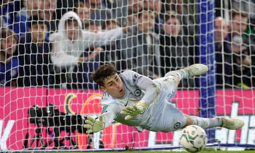 Kepa Arrizabalaga dives to his right to save a penalty.