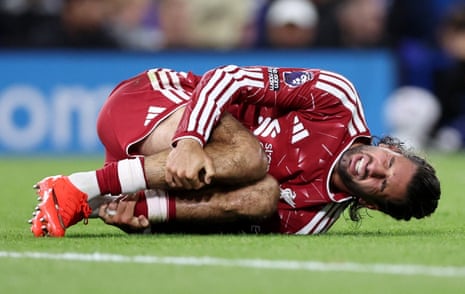 Liverpool's Dominik Szoboszlai reacts after a challenge from Ipswich Town's Leif Davis before a VAR penalty review.