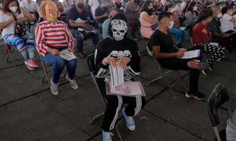 A young woman dressed as a skeleton waits to receive the first dose of the Sinovac vaccine.