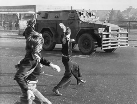 belfast troubles northern ireland british army vehicle boys throwing rocks and bottles