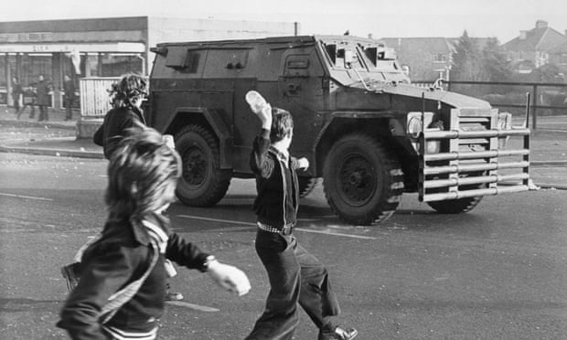 Belfast boys throwing objects at a British armed vehicle in May 1976.