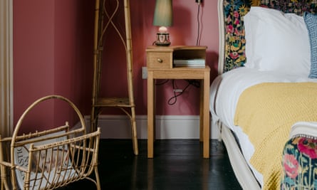 In the pink: a rhubarb bedroom with dark gloss floors.