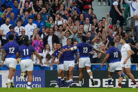 Samoa’s Nigel Ah Wong celebrates with teammates after he scored their second try.