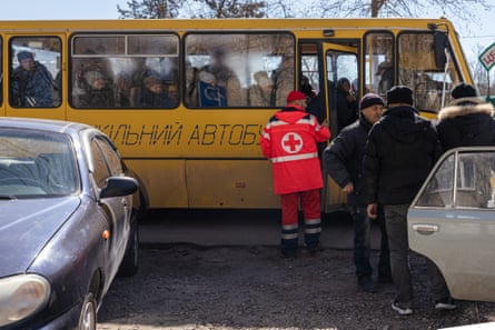 Evacuees from war-torn villages arrive at a Red Cross refugee centre.