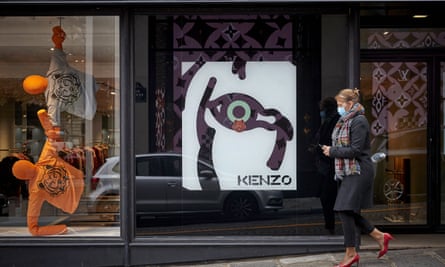 A Parisian walks past the flagship Kenzo store near the Champs Elysees.