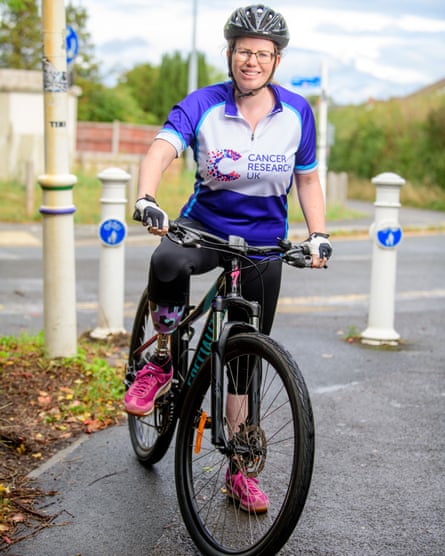 Christine Lote wears a Cancer Research UK T-shirt connected a bike.