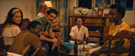 Group of people sat around in a 70s living room