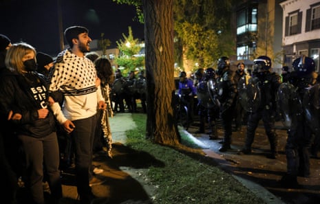 Demonstrators stand facing police officers as people march during a multi-denominational event hosted by the Democratic Socialists of America, IfNotNow Movement and Jewish Voice for Peace calling for a ceasefire in the conflict between Israel and Palestinian Islamist group Hamas, in Washington, U.S. November 15, 2023.