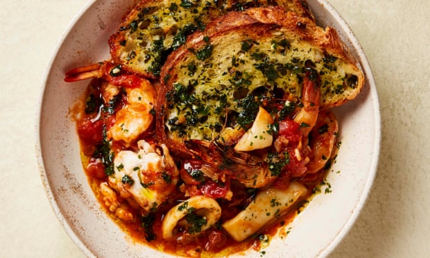 Yotam Ottolenghi’s seafood stew with sourdough crust.