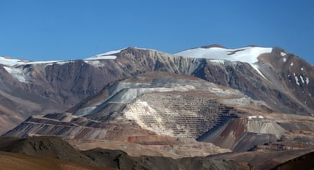 An open pit mine in a mountain range.