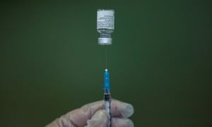 A medical worker fills a syringe with Pfizer-BioNTech vaccine.