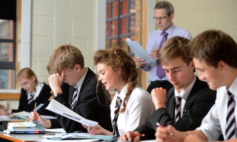 Junior high school students enjoying lesson at desks in classroom Stock  Photo - Alamy