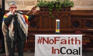 Rabbi Jonathan Keren-Black uses a rabbinical horn (shofar) to sound the end of the era of coal