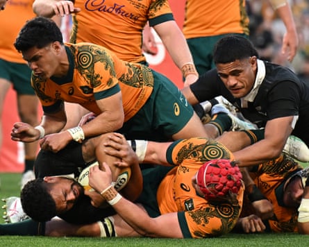 Ardie Savea of the All Blacks attempts to score a try while being tackled by Noah Lolesio and Fraser McReight of the Wallabies