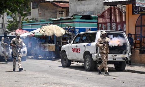 Police officers fire tear gas at demonstrators during a protest against insecurity in Port-au-Prince, Haiti.