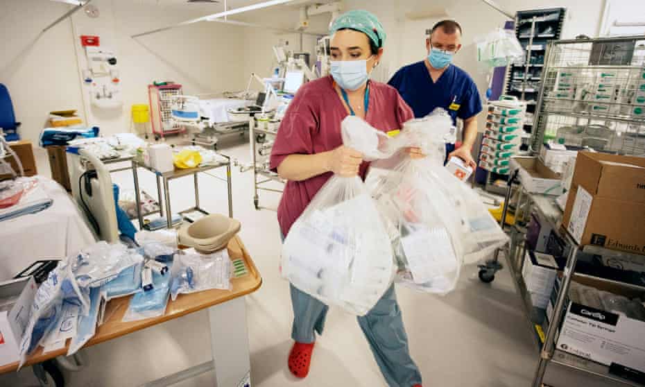 Hospital staff spend New Years eve turning surgical theatres and recovery departments into intensive care wards for the influx of sick Covid 19 patients. 