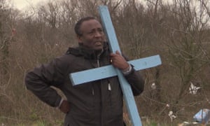 Ethiopian pastor Rev Teferi Shuremo watches as his church is destroyed at a migrant camp in Calais