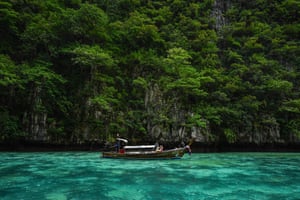 Tourists in a longtail boat visiting Thailand’s Phi Phi Leh island