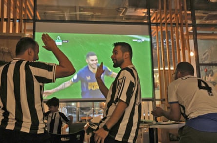 Saudi Newcastle United fans celebrate a goal against Tottenham Hotspur as they watch the game at a cafe in Riyadh last October.