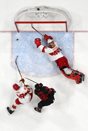 China’s goaltender Jeremy Smith stretches for the puck as Jordan Weal (out of frame) scores Canada’s first goal.