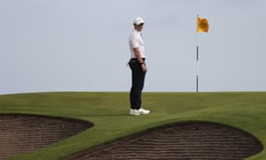 Rory McIlroy looks at the bunkers in front of the tenth green.