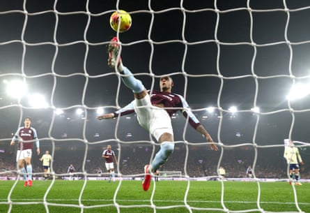 Ezri Konsa of Aston Villa attempts to clear the ball off the line.
