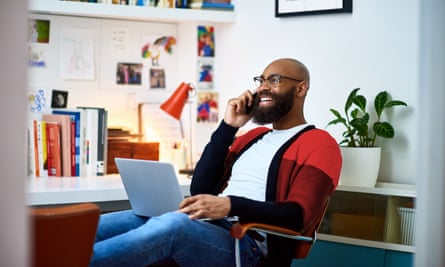 A man working from home on phone and laptop.