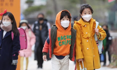 Children wear masks as they head to school in Sejong, South Korea.