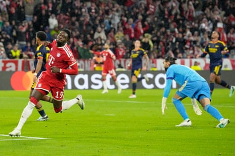 Alphonso Davies celebrates scoring as the Arsenal goalkeeper reacts nearby
