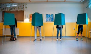 People cast their votes in booths at a polling station in Stockholm.