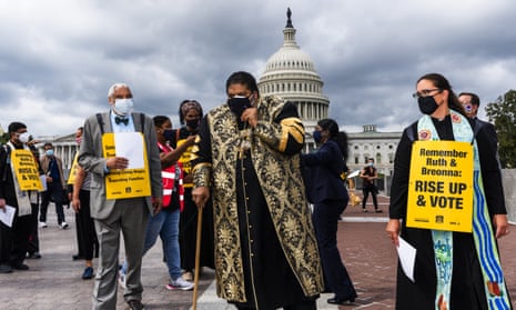 Reverend William Barber II, center, leads leaders of various faiths gathered near the US Capitol and march silently to the supreme court and towards the Dirksen Senate office building to remember Ruth Bader Ginsburg and Kentucky police shooting victim Breonna Taylor. They urged Americans to vote in their memory.