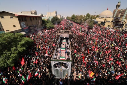 People gather during the funeral procession of Iran’s slain supreme leader Ali Khamenei and his family members in Tehran on Monday.