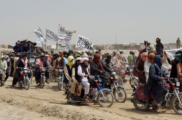 Men on motorbikes with Taliban flags crossing the Pakistan-Afghanistan border at Chaman, Balochistan.