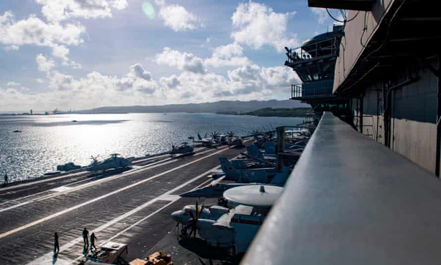 The island of Guam seen from the deck of the USS Theodore Roosevelt. The relationship between the US navy and the islands of Guam and the Northern Marianas are generally strong, but strained over the issue of environmental damage.
