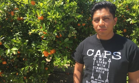Angel Garcia by an orange grove in Tulare County