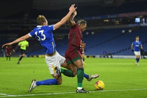 Brighton’s English defender Dan Burn (L) fouls Wolverhampton Wanderers’ Spanish midfielder Adama Traore.