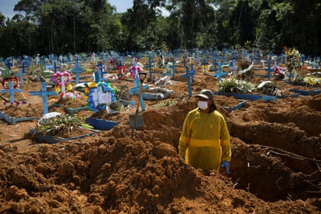 A gravedigger works at the Parque Taruma cemetery amid the coronavirus outbreak in Manau, one of the worst in the country.