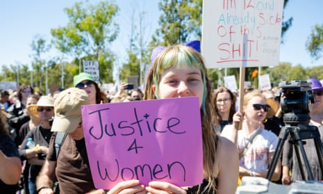 teen girl holds sign saying "justice 4 women"