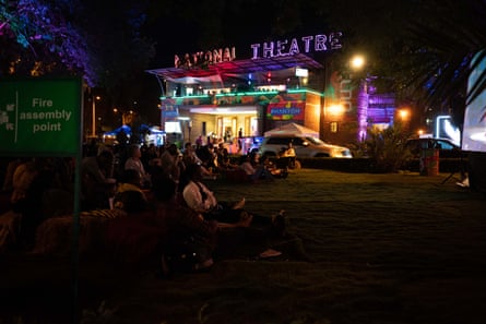 People watch an outdoor live screening of Yo-Yo Ma’s Nairobi performance