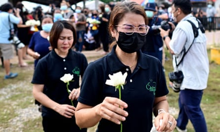 Women clasp achromatic roses to spot connected the steps of the nursery, wherever a erstwhile constabulary serviceman killed astatine slightest 37 people