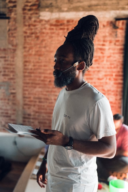 A man with a notepad leads a healing circle.
