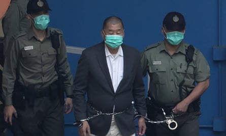 A shackled Jimmy Lai is escorted to a Hong Kong court hearing in December 2020.